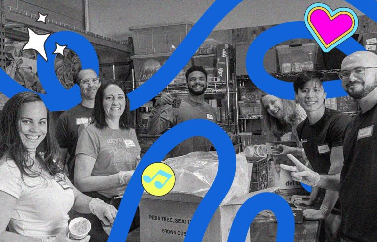 People smiling while they pack food.